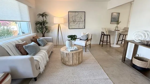 a living room with furniture and a large window