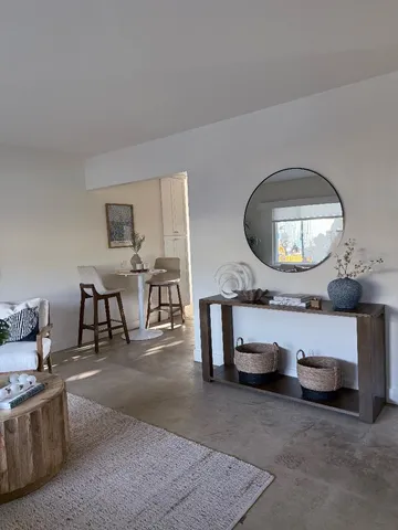 a living room with furniture and a mirror