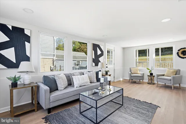 a living room with furniture and kitchen
