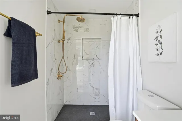 a bathroom with a sink a toilet and mirror