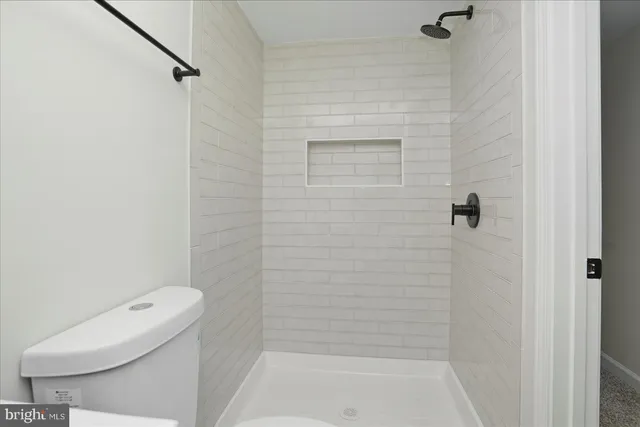 a bathroom with a toilet and a mirror