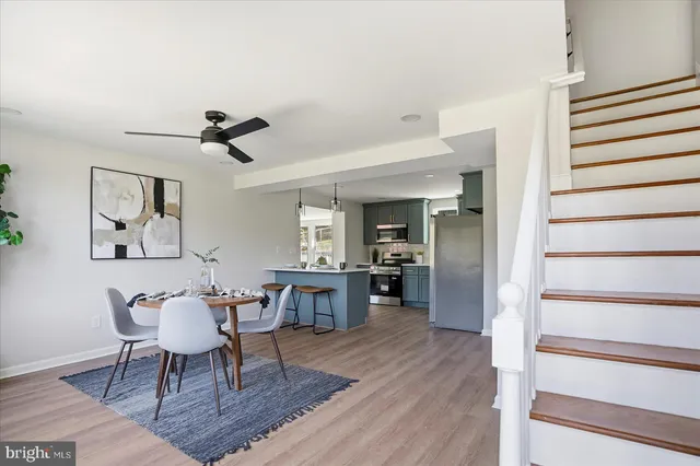 a dining room with furniture a chandelier and wooden floor