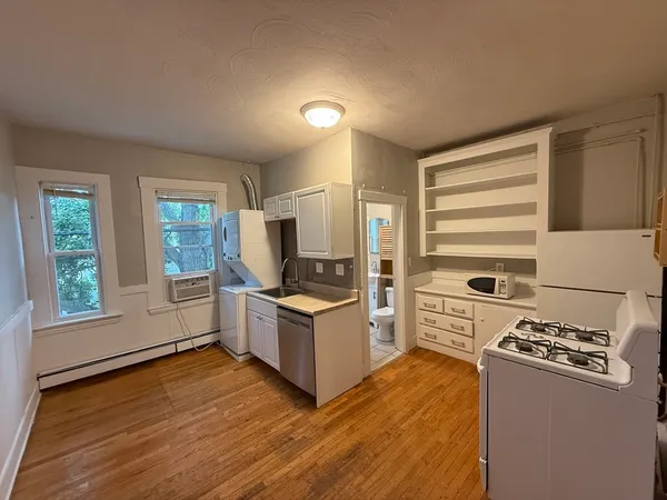 a kitchen with granite countertop a stove and a refrigerator