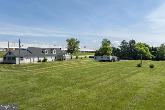 a view of a field with an trees in the background