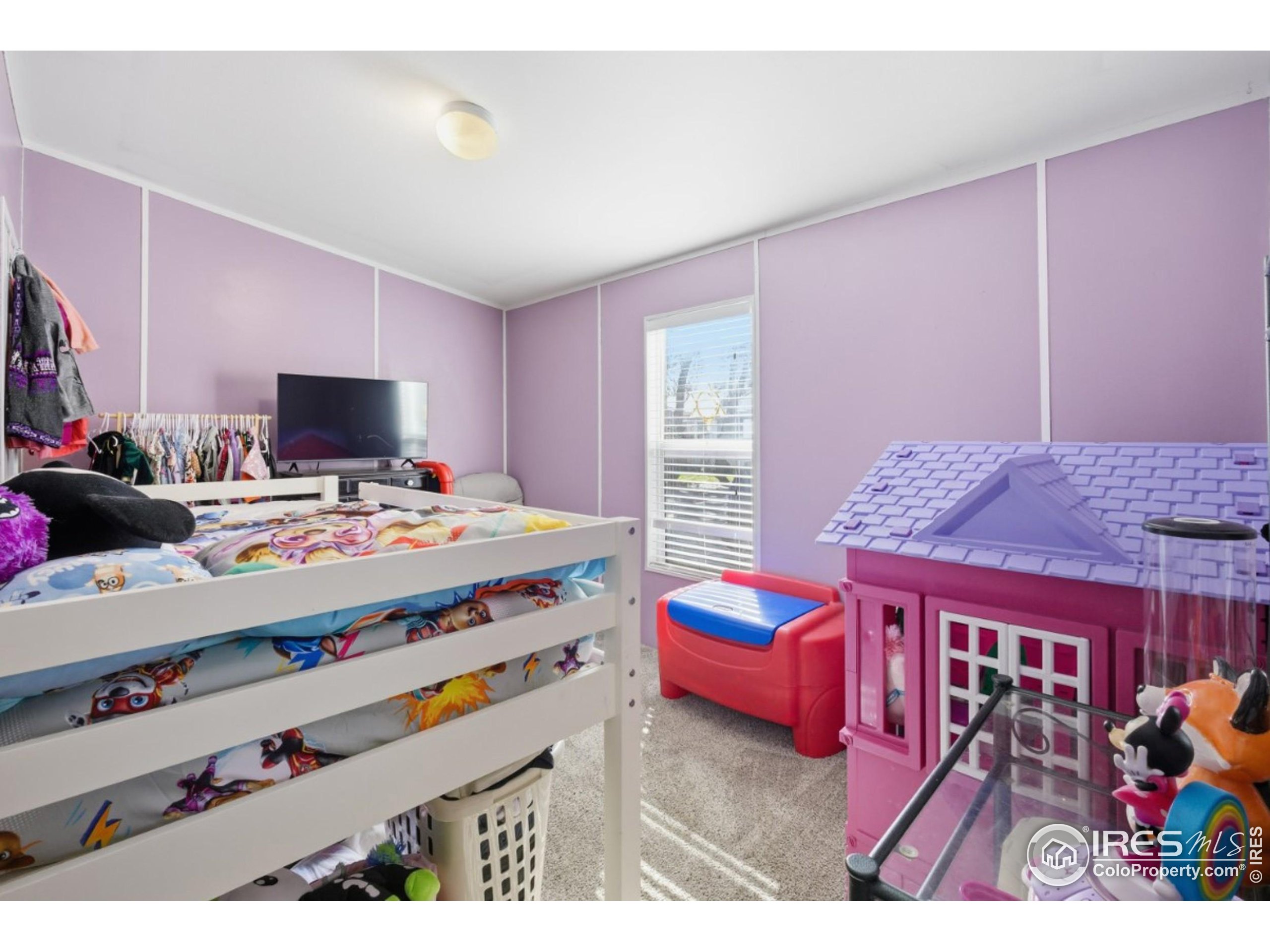 2500 East Harmony Road, Unit 84 Fort Collins, CO 80528 - Photo 13 of 18 a bed room with a bed and a tv