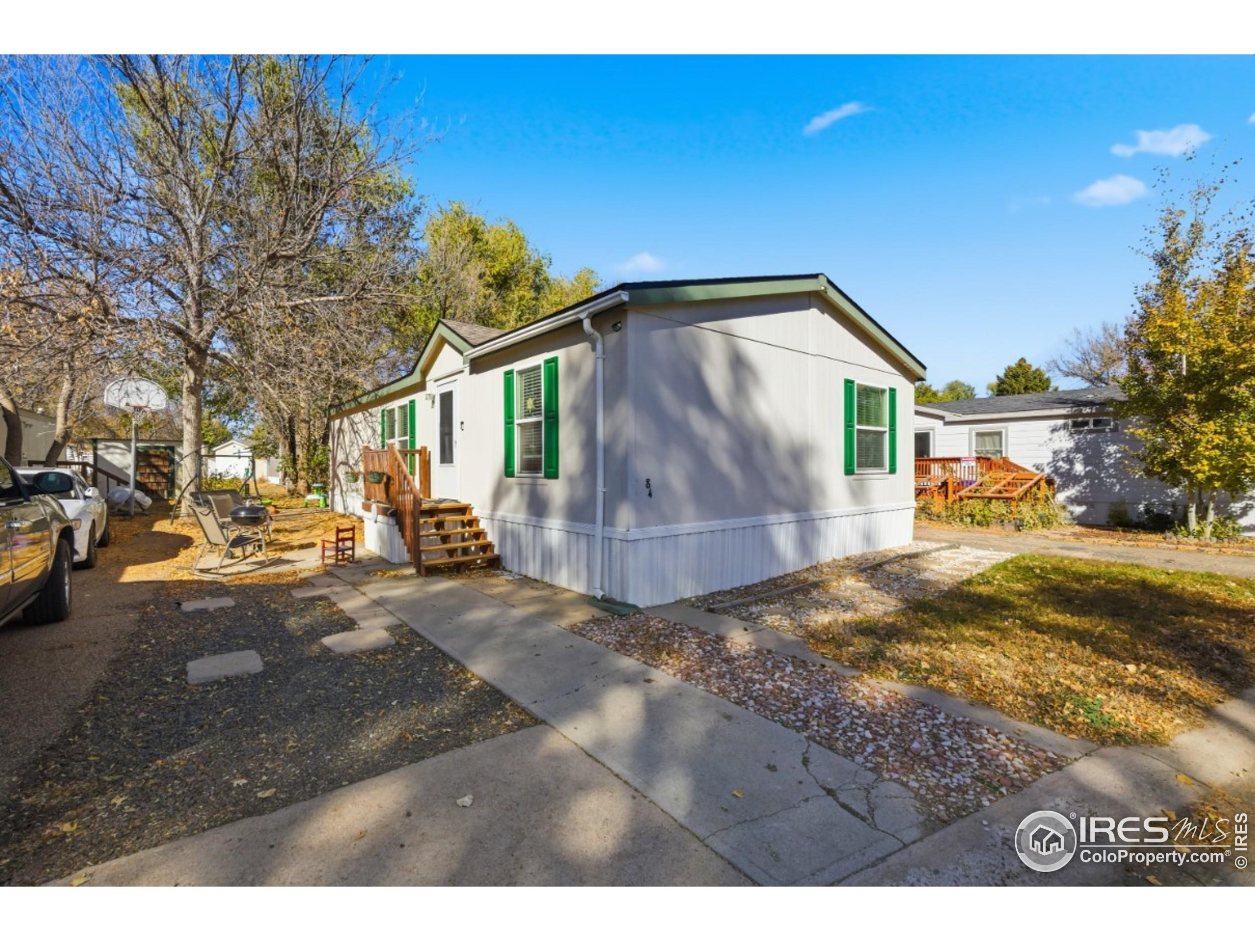2500 East Harmony Road, Unit 84 Fort Collins, CO 80528 - Photo 2 of 18 a view of a yard with a house in the background