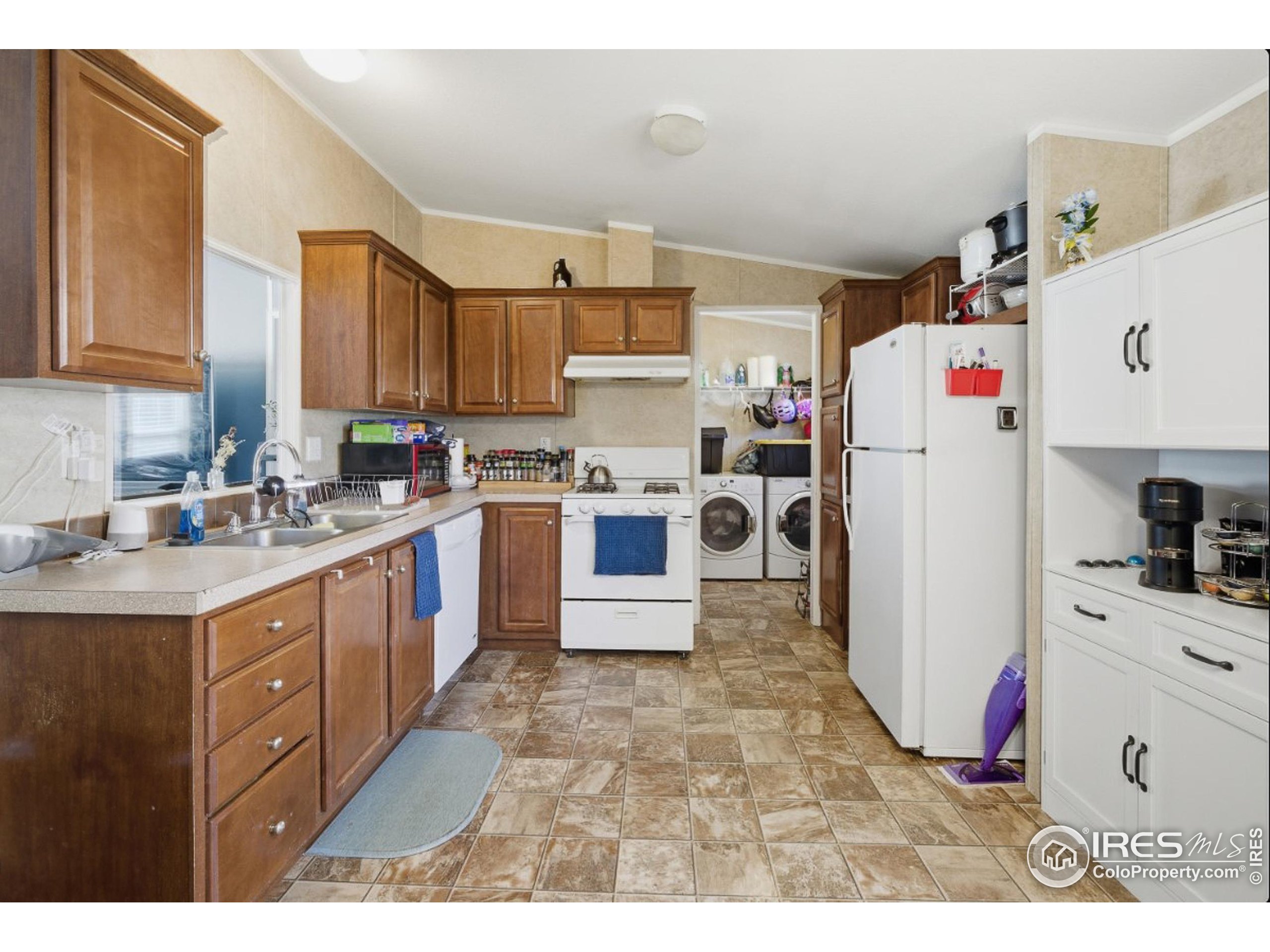 2500 East Harmony Road, Unit 84 Fort Collins, CO 80528 - Photo 7 of 18 a kitchen with a stove a refrigerator and a sink