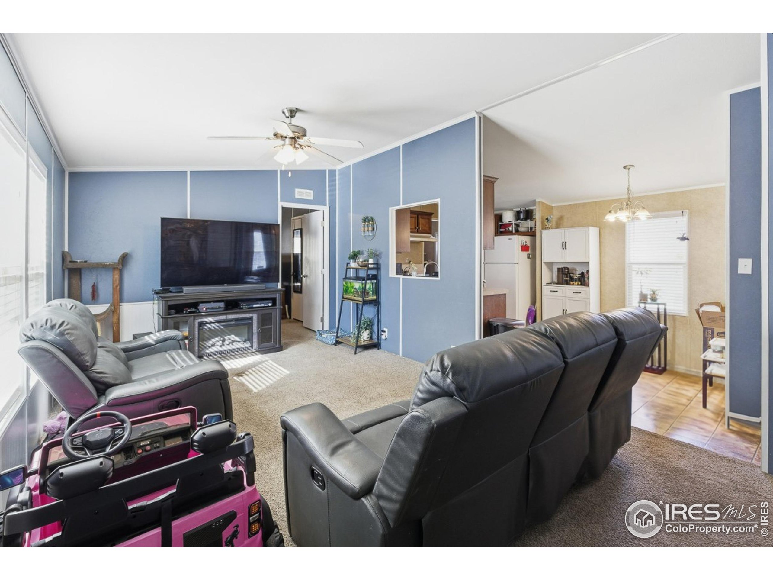 2500 East Harmony Road, Unit 84 Fort Collins, CO 80528 - Photo 9 of 18 a living room with furniture and a flat screen tv