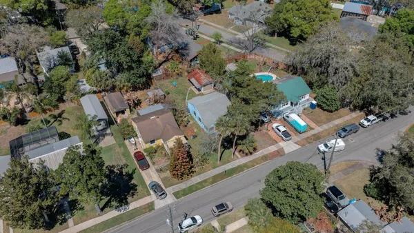 an aerial view of a house with a yard and a fountain