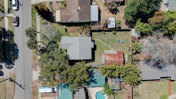 a view of a big yard with lots of bushes