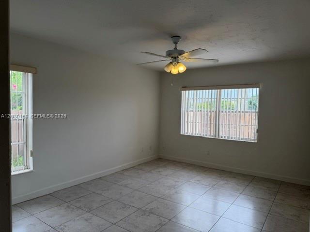 11206 Southwest 125th Place, Unit 11206 Miami, FL 33186 - Photo 10 of 15 an empty room with windows and fan