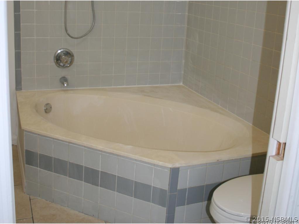 2429 Unity Tree Drive Edgewater, FL 32141 - Photo 13 of 24 a bathroom with a toilet and a shower