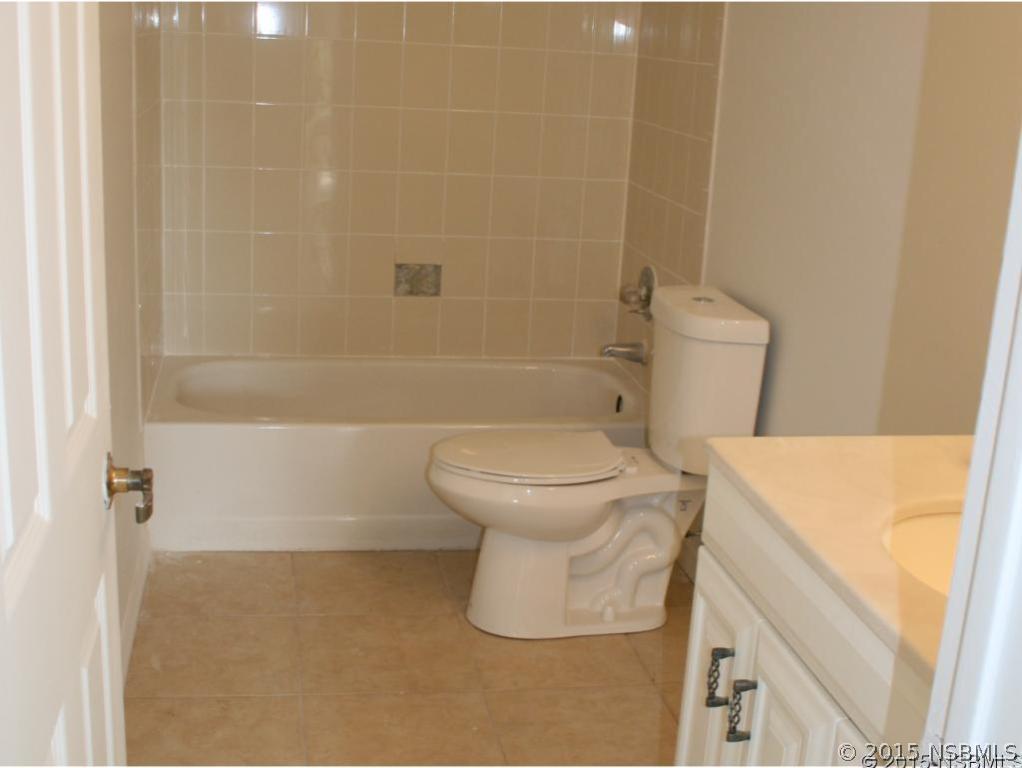 2429 Unity Tree Drive Edgewater, FL 32141 - Photo 17 of 24 a bathroom with a toilet and a shower