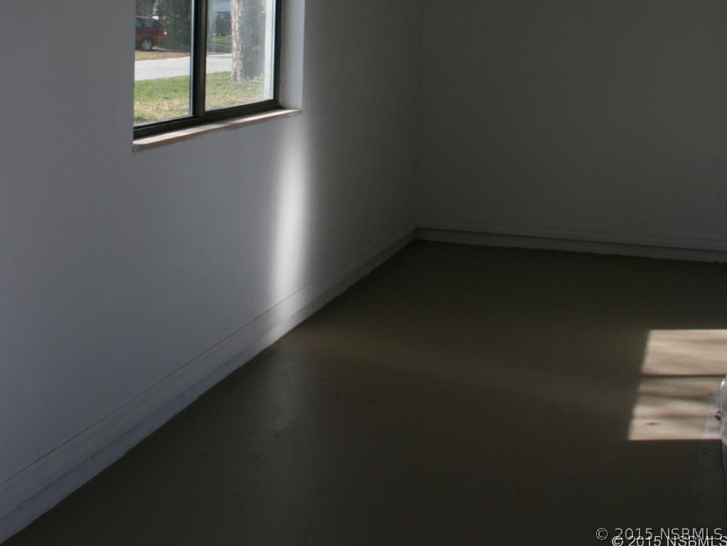 2429 Unity Tree Drive Edgewater, FL 32141 - Photo 23 of 24 a view of a room with wooden floor and windows