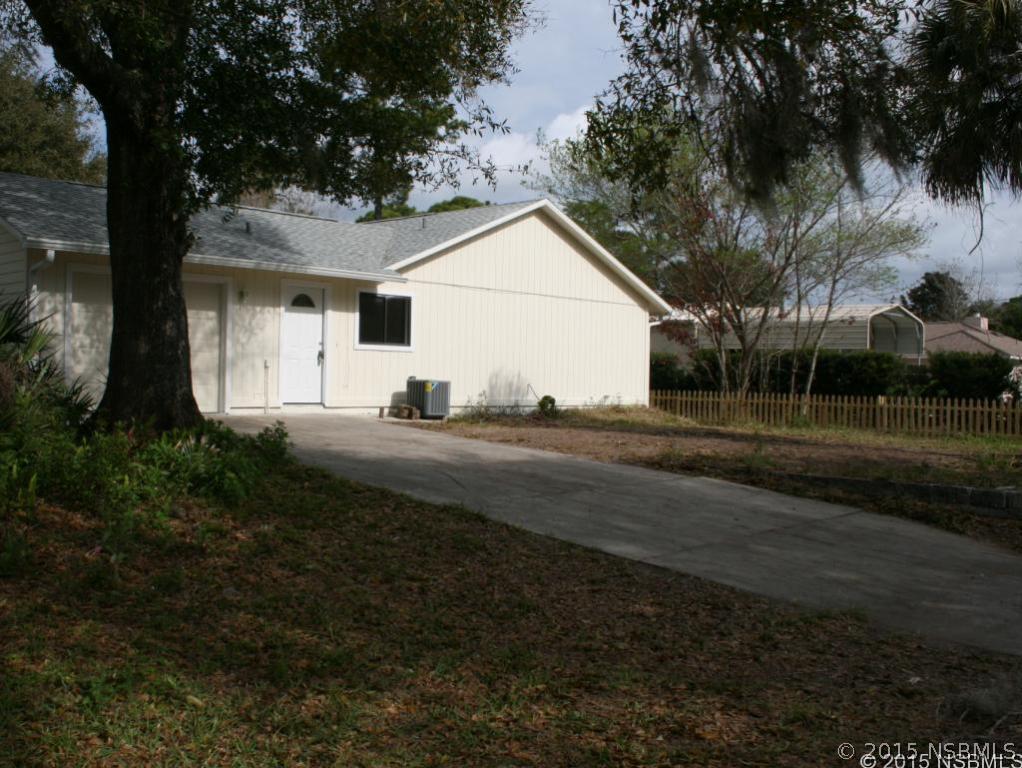 2429 Unity Tree Drive Edgewater, FL 32141 - Photo 3 of 24 a backyard of a house with lots of green space