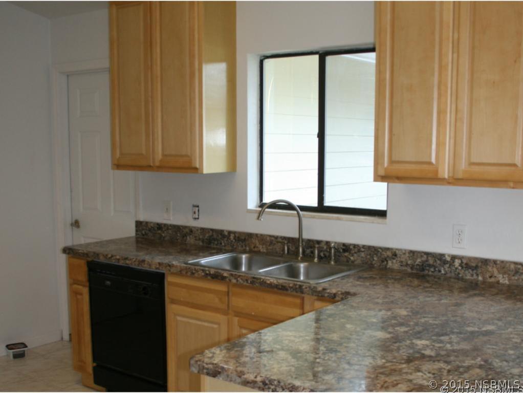 2429 Unity Tree Drive Edgewater, FL 32141 - Photo 7 of 24 a bathroom with a granite countertop sink and a mirror