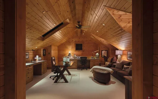 a living room with fireplace furniture and a large window