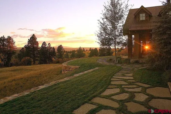 a view of a livingroom with furniture and floor to ceiling window