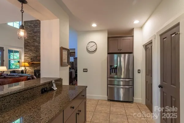 a kitchen with stainless steel appliances granite countertop a refrigerator a oven and a sink