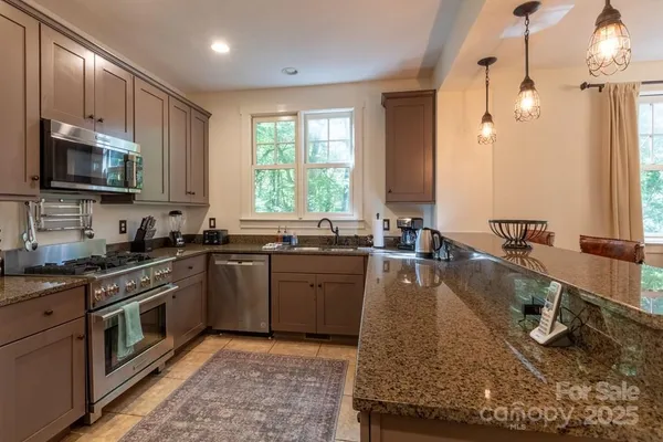 a kitchen with a stove sink cabinets and appliances
