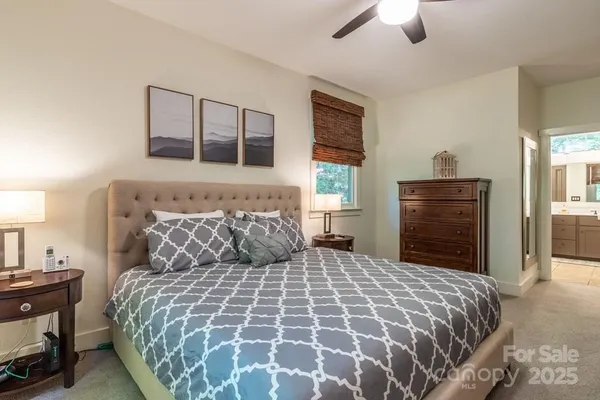 a bedroom with a large bed and a dresser