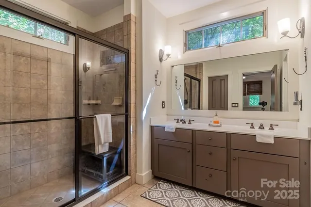a bathroom with a double vanity sink and a mirror