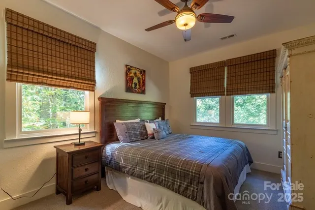 a bedroom with a large bed and a window