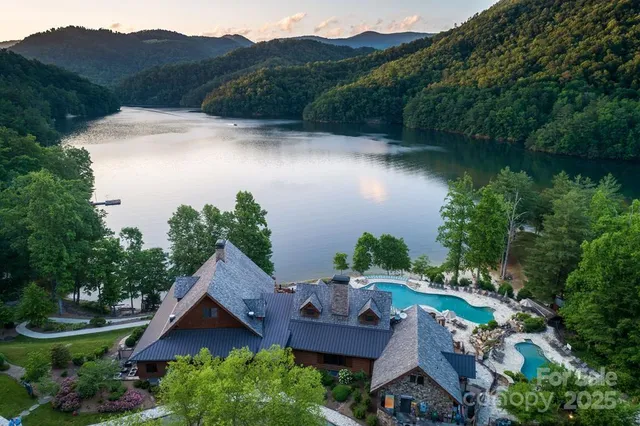 an aerial view of house with yard and lake view