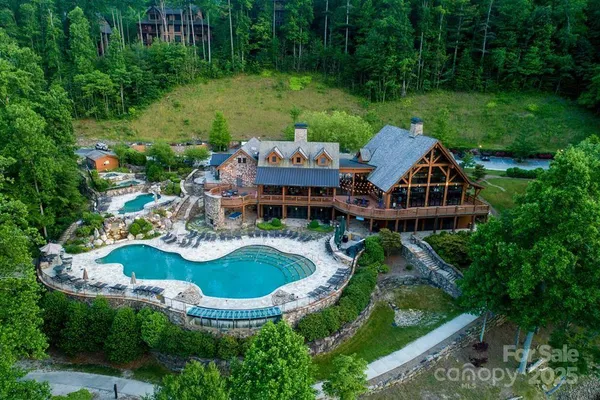 an aerial view of a house with garden space and swimming pool
