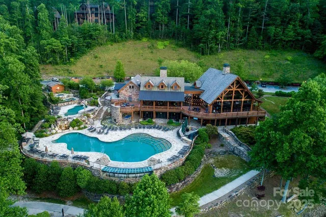an aerial view of a house with garden space and swimming pool