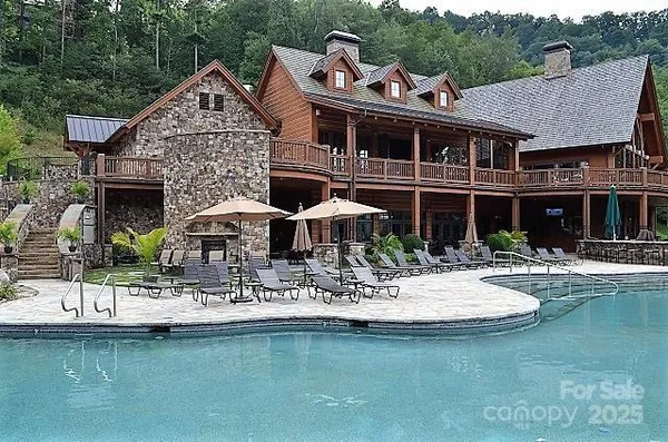 a front view of a house with swimming pool having outdoor seating