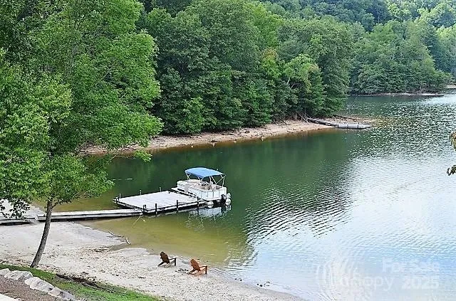 an aerial view of a house with a garden and lake view