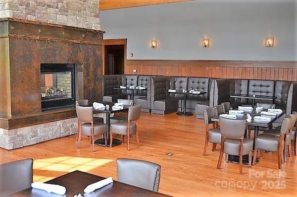 a dining room with furniture a rug and a fireplace