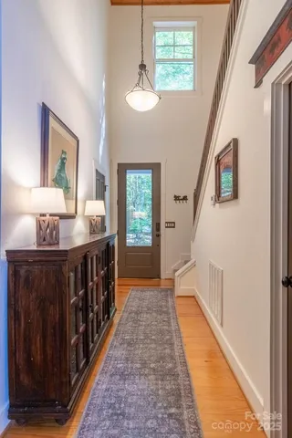 a view of an entryway wooden floor and windows