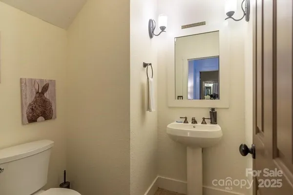 a bathroom with a sink toilet and mirror