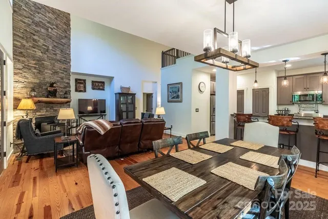a living room with furniture a chandelier and a dining table