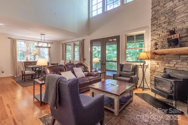 a living room with fireplace furniture and a large window