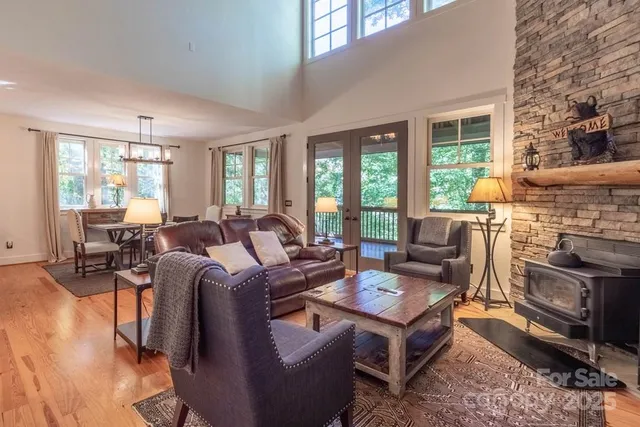 a living room with fireplace furniture and a large window