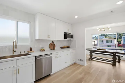 a kitchen with sink and cabinets