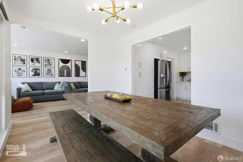 a living room with furniture and kitchen view