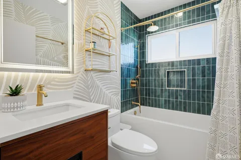 a bathroom with a sink a toilet and bathtub