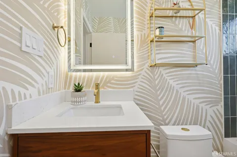 a bathroom with a sink a toilet and shower curtain
