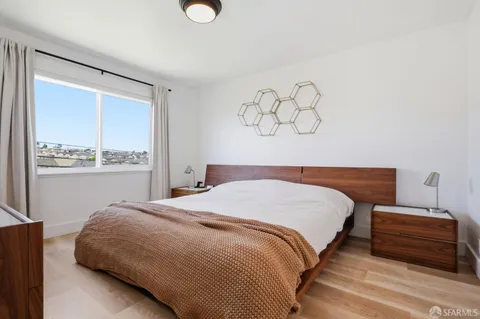a bedroom with a bed and window