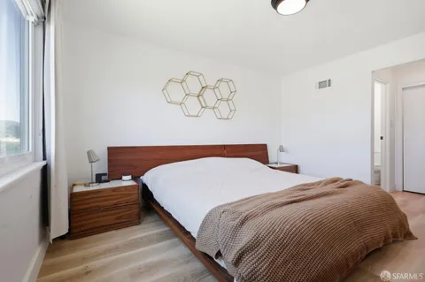 a bedroom with a bed and cabinets