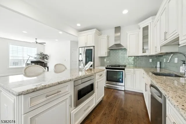 a kitchen with a stove sink and cabinets