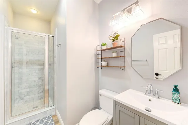 a bathroom with a sink toilet and shower