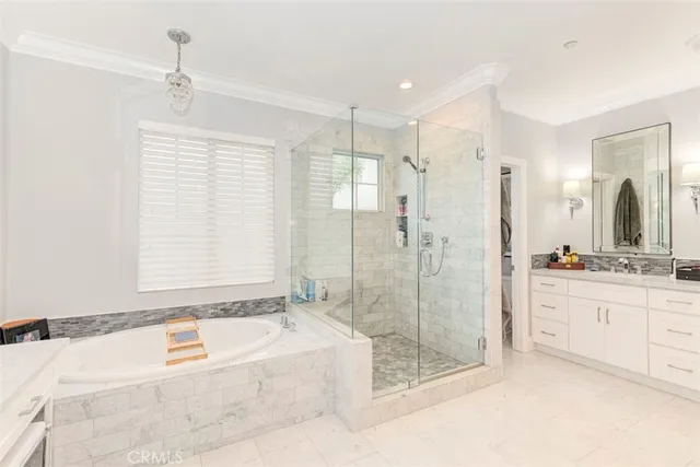 a spacious bathroom with a granite countertop tub sink a shower and a mirror