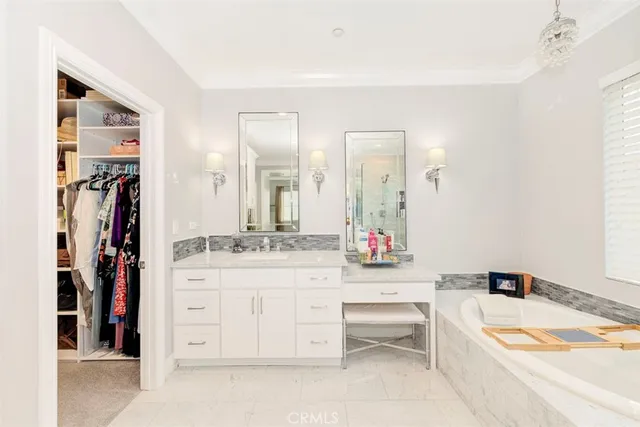 a bathroom with a granite countertop sink mirror bathtub and toilet