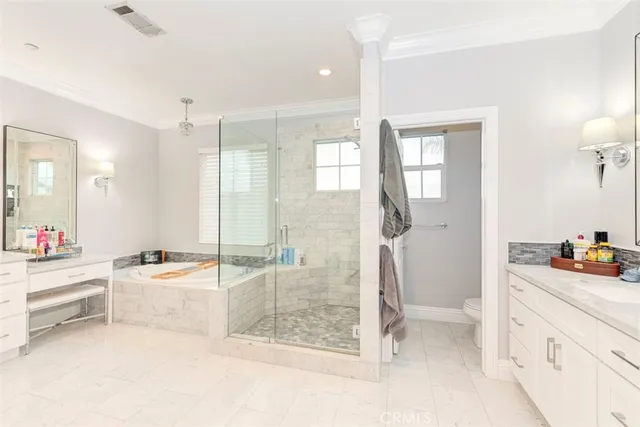 a bathroom with a tub sink a mirror a shower and vanity