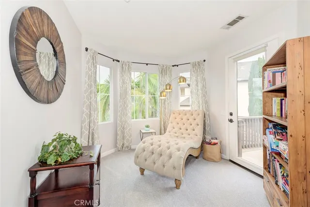 a living room with furniture and a book shelf